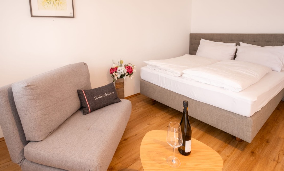 Modern apartment with double bed, seating area and living space